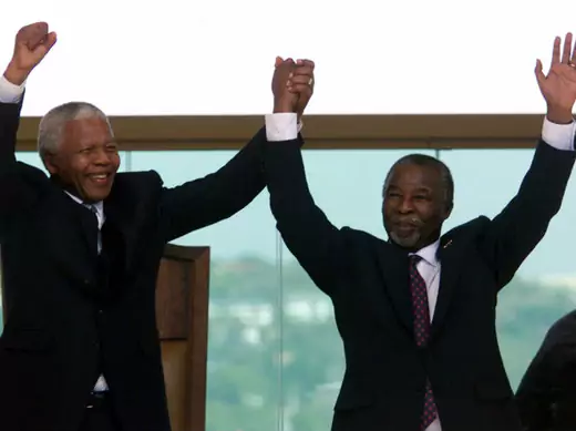 Former South African President Nelson Mandela (L) raises the hand of the new President, Thabo Mbeki after he took the oath of office at the Union Buildings in Pretoria June 16.