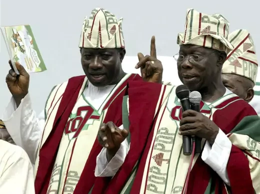 Nigeria's President Olusegun Obasanjo (R) and the People's Democratic Party's (PDP) vice presidential candidate Goodluck Jonathan (left) speaks during a PDP presidential campaign rally in Ibadan March 8, 2007.