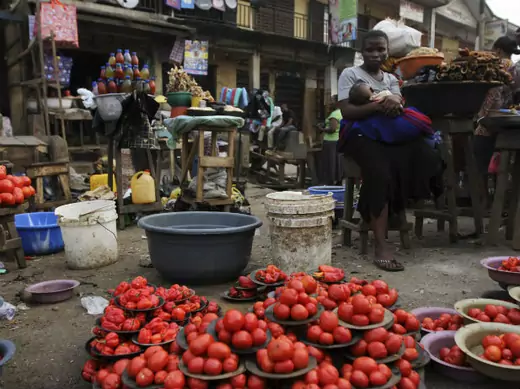 A woman waits for customer at a local food market after the suspension of a nationwide strike by labour unions, in Nigeria's commercial capital Lagos January 16, 2012.