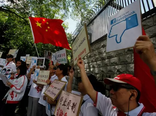 Demonstrators from the pro-China "Caring Hong Kong Power" group protest over claims from former U.S. spy agency contractor Edward Snowden that the National Security Agency (NSA) hacked computers in the Chinese territory, outside the U.S. Consulate in Hong Kong on July 9, 2013. (Bobby Yip/Courtesy Reuters)