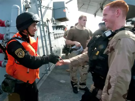 A member of the visit, board, search and seizure (VBSS) team aboard the guided-missile destroyer USS Winston S. Churchill (R) shakes hands with a member of the VBSS team from the Chinese People's Liberation Army (Navy) frigate Yi Yang following a bilateral counter-piracy exercise in the Gulf of Aden, September 17, 2012. (U.S. Navy/Mass Communication Specialist 2nd Class Aaron Chase/Courtesy Reuters)