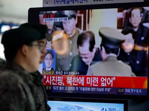South Korean soldiers walk past a television showing reports on the execution of Jang Song-taek, who is North Korean leader Kim Jong-un's uncle, at a railway station in Seoul on December 13, 2013. (Kim Hong-ji/Courtesy Reuters)