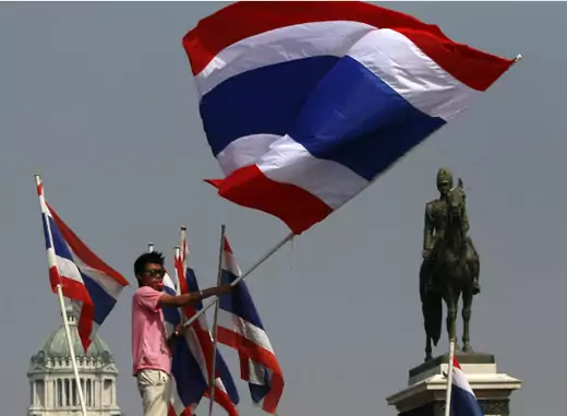 An anti-government protester waves a Thai national flag during a rally at the Royal Plaza near the Government House in Bangkok on December 9, 2013. (Chaiwat Subprasom/Courtesy Reuters) 
