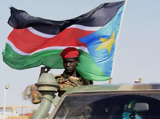 An SPLA soldier stands on the back of a pick-up truck in Bentiu, Unity state January 12, 2014.