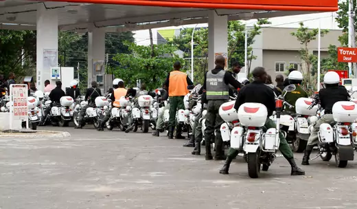 Police queue at a petrol station to pump their motorcycles with fuel before the start of the governorship election in Nigeria's northern state of Kaduna April 28, 2011.