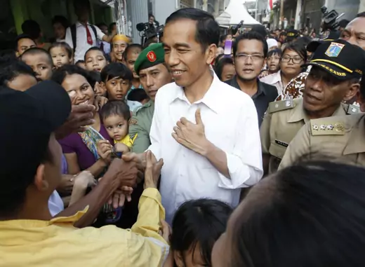 Jakarta's Governor Joko Widodo, also known as Jokowi, is surrounded by residents during his visit to inspect the aftermath of a slum fire area in west Jakarta on April 9, 2013. (Enny Nuraheni/Courtesy Reuters) 