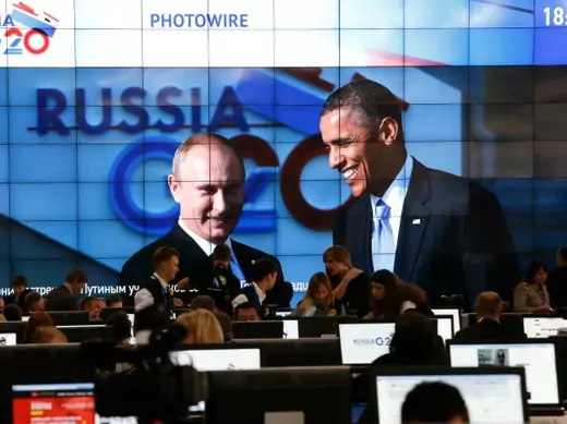 Russian President Vladimir Putin (L) and U.S. President Barack Obama are pictured on a video screen installed in the press centre of the G20 Summit in Strelna near St. Petersburg on September 5, 2013. (Grigory Dukor/Courtesy Reuters)