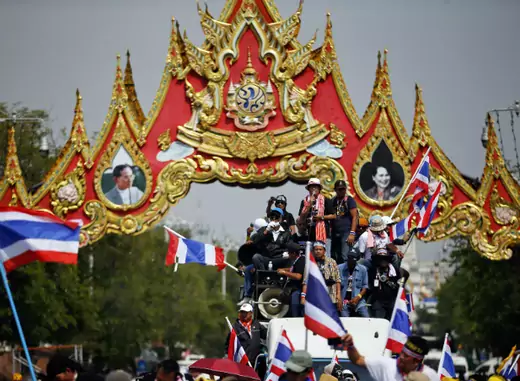 Anti-government protesters celebrate under portraits of Thailand's King Bhumibol Adulyadej and Queen Sirikit as they enter the area near the Government house in Bangkok on December 3, 2013. (Damir Sagolj/Courtesy Reuters)