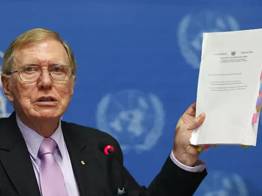 Kirby, Chairperson of the Commission of Inquiry on Human Rights in North Korea holds a copy of his report during a news conference at the United Nations in Geneva