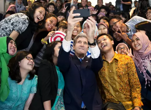 U.S. Secretary of State John Kerry takes a selfie with a group of students before delivering a speech on climate change in Jakarta on February 16, 2014. (Pool New/Courtesy Reuters) 