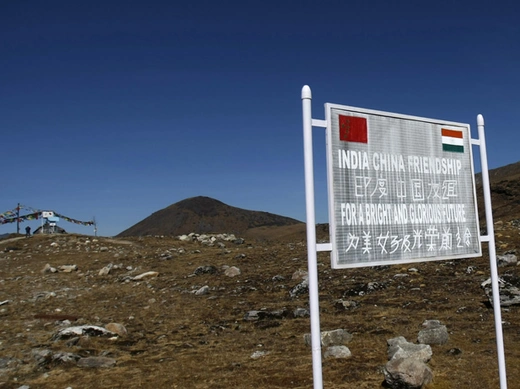 A signboard is seen from the Indian side of the Indo-China border at Bumla