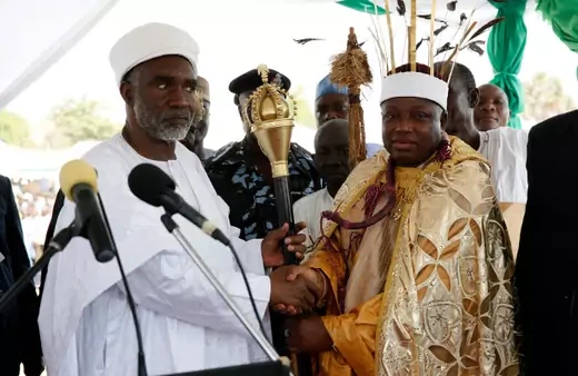 Kwire-Mana, Kpafrato II, Homun Honest Stephen (R), receives his staff of office from Adamawa State Governor, Murtala Nyako, during a presentation ceremony at Makwada Square in Numan, Adamawa state, December 7, 2013.