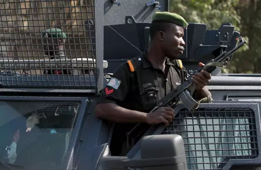 A police officer keeps watch during a protest against the elimination of a popular fuel subsidy that has doubled the price of petrol, in Nigeria's capital Abuja January 9, 2012. r armed