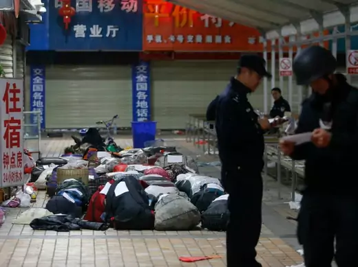 Policemen check unclaimed luggage at a square outside the Kunming railway station after a knife attack, in Kunming, Yunnan province on March 2, 2014. (Stringer/Courtesy Reuters)
