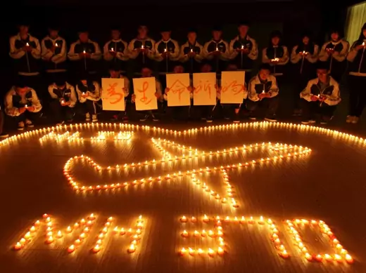 International school students light candles to pray for passengers aboard Malaysia Airlines flight MH370, in Zhuji, Zhejiang province, on March 10, 2014. (Stringer/Courtesy Reuters)