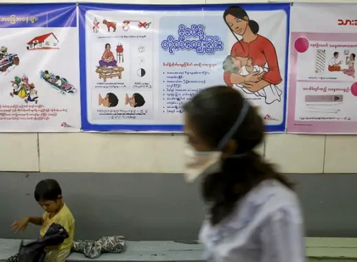 A nurse walks past as a child sitting at Medecins Sans Frontieres Holland's clinic in Yangon on March 3, 2014. (Minzayar Minzayar/Courtesy Reuters) 