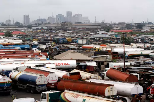 Trucks are seen parked around an automobile workshop overlooking the Lagos business district at the Orile-Iganmu in Lagos August 29, 2013.