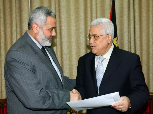 Palestinian prime minister Ismail Haniyeh shakes hands with President Mahmoud Abbas after handing him an agreed list of ministers for a new unity government, in Gaza March 15, 2007 in this picture released by the Palestinian Press Office (PPO) (Abu Askar/Courtesy Reuters).