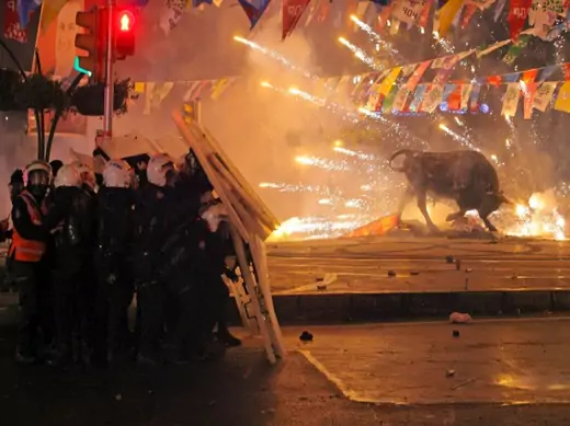 Riot policemen shield themselves as fireworks thrown by protesters explode next to the statue of a bull during an anti-government, anti-corruption protest in Istanbul, Turkey, March 11, 2014 (Courtesy Reuters/Stringer). 