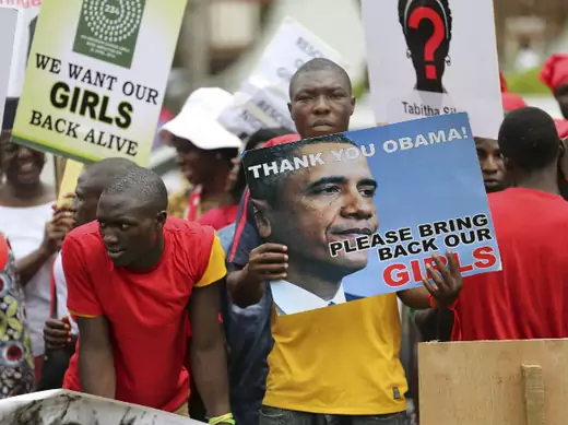 People carry signs as they attend a protest demanding the release of abducted secondary school girls in the remote village of Chibok, in Lagos May 9, 2014.