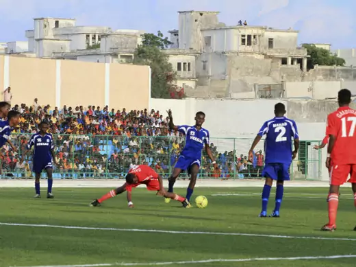 Players from Heegan (blue shirt) compete against players from Gaaddidka (red shirt) during the first soccer match of the Somalia Premier League at the Banadir stadium in Mogadishu November 8, 2013. 