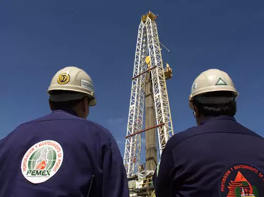MEXICAN PEMEX OIL ENGINEERS WATCH WORK ON A DRILLING PLATFORM IN TABASCO.