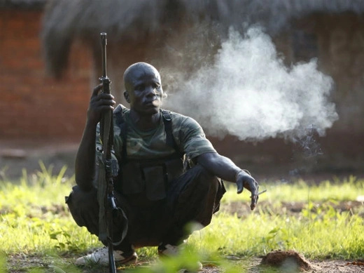 A Seleka fighter takes a break during a patrol as he searches with other Seleka fighters for Anti-Balaka Christian militia members near the town of Lioto June 6, 2014.