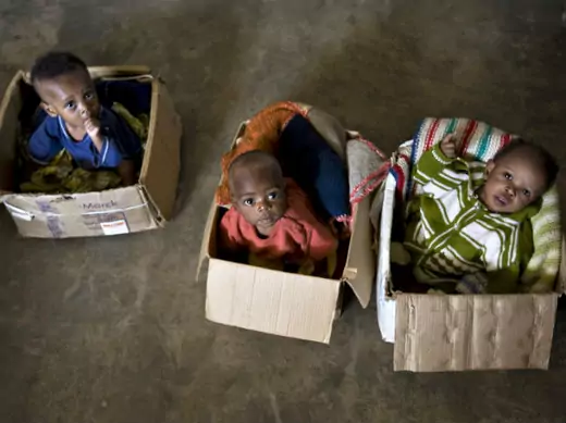 War-orphaned children sit in cardboard boxes at the Kizito orphanage in Bunia in northeastern Congo, February 24, 2009. (Finbarr O'Reilly/Courtesy Reuters)