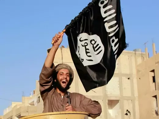 A militant Islamist fighter in Ra’qqa province celebrates the declaration of an Islamic "caliphate" in Iraq and Syria on June 30, 2014. (Stringer/Courtesy Reuters).