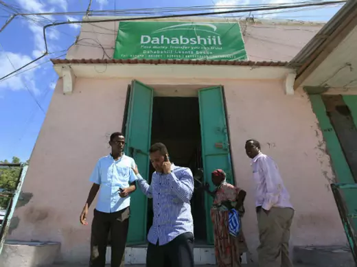 Customers walk out of a Dahabshiil money transfer office in "Kilometer Five" street of Soobe village, southern Mogadishu, May 8, 2013.