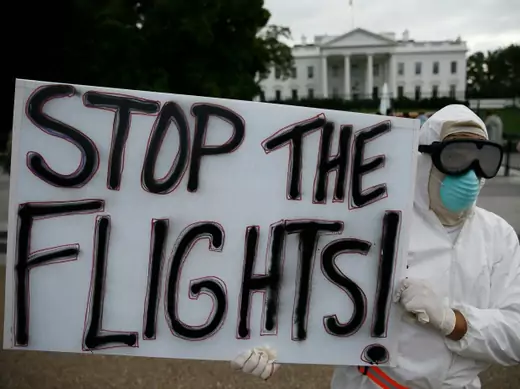 Protestor Jeff Hulbert of Annapolis, Maryland holds a sign reading "Stop the Flights" as he demonstrates in favor of a travel ban to stop the spread of the Ebola virus, in front of the White House in Washington October 16, 2014. REUTERS/Jim Bourg (UNITED STATES - Tags: POLITICS HEALTH CIVIL UNREST TPX IMAGES OF THE DAY)