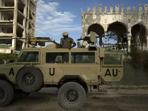An African Union Mission in Somalia (AMISOM) soldier stands guard atop an armored vehicle in Mogadishu, Somalia, November 2013.