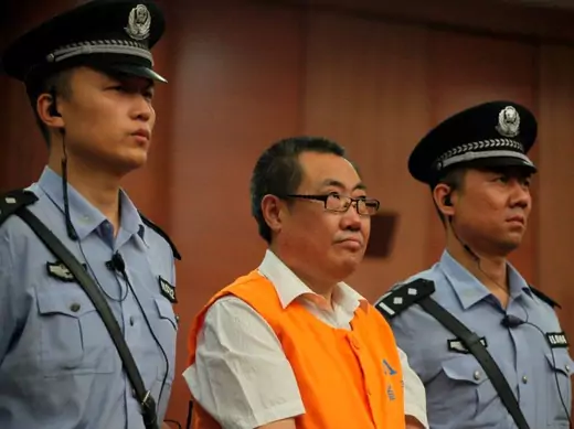 Yang Dacai, a former provincial official, listens to a verdict at a court in Xi'an, Shaanxi province, September 5, 2013. The court jailed Yang for 14 years on Thursday for corruption after pictures of him grinning at the scene of an accident and wearing expensive watches went viral online, earning him the nickname "watch brother". A picture of the rotund Yang Dacai smiling while inspecting the scene of a bus accident in which 36 people died last year provoked outrage, and criticism grew when pictures of hi
