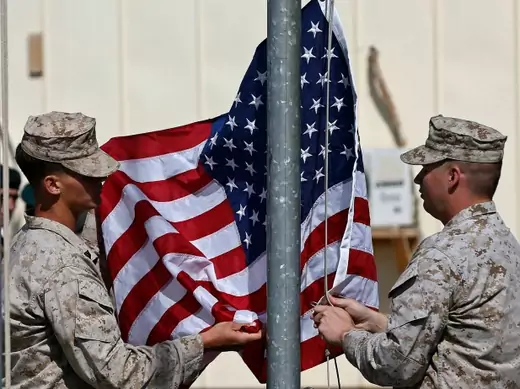 U.S. Marines lower their flag during a handover ceremony, as the last U.S. Marines unit and British combat troops end their Afghan operations, in Helmand, Afghanistan, October 26, 2014 (Courtesy Reuters/Omar Sobhani ).