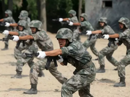 Members of People's Liberation Army (PLA) coastal defence force shout as they practise during a drill to mark the upcoming 87th Army Day at a military base in Qingdao, Shandong province July 29, 2014. The PLA Army Day falls on August 1 every year. Chinese President Xi Jinping has pledged to strike hard against graft in the military, urging soldiers to banish corrupt practices and ensure their loyalty to the ruling Communist Party, state media reported on Friday. Picture taken July 29, 2014. REUTERS/Stringe
