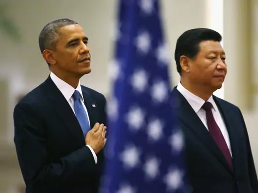 U.S. President Barack Obama and China's President Xi Jinping listen to national anthems behind a U.S. flag during a welcoming ceremony at the Great Hall of the People in Beijing (Petar Kujundzic/Reuters).