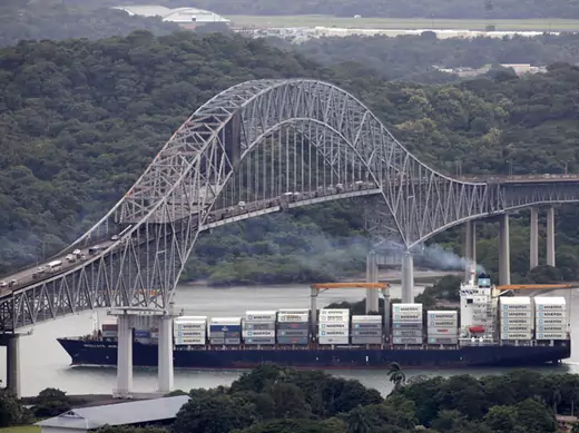 A container ship sails underneath the Bridge of the Americas in the Panama Canal in Panama City August 14, 2014 (Rafael Ibarra/Reuters).