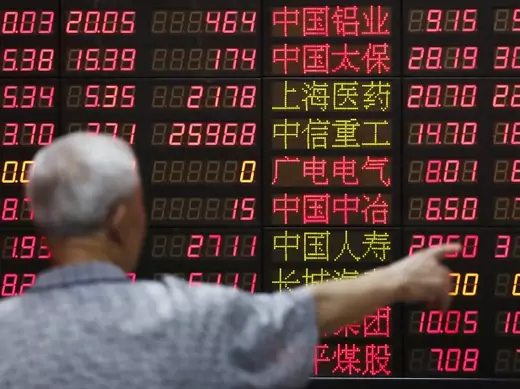 An investor looks at information displayed on an electronic screen at a brokerage house in Shanghai, China, June 30, 2015. China stocks ended Tuesday sharply higher, reversing a tumble in morning trade, as a slew of government measures to stem a two-week-long market tumble appeared to win back some investor confidence (Aly Song/Reuters).