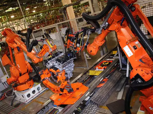 Automated robots work on a 3500 Duramax engine as it moves along the assembly line at the Ford Lima Engine Plant in Lima, Ohio (Aaron Josefczyk/Reuters).