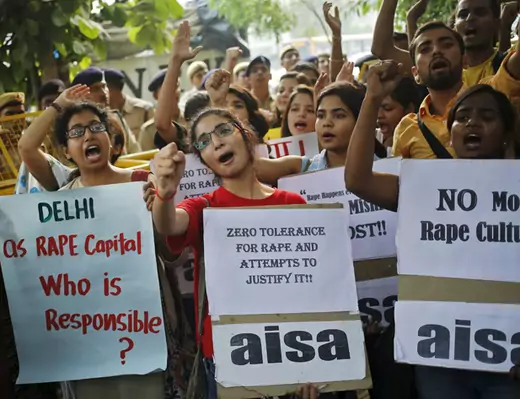 Members of AISA shout slogans as they hold placards during a protest outside police headquarters in New Delhi