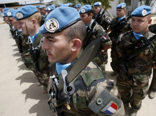 French peacekeepers of the United Nations Interim Force in Lebanon (UNIFIL) stand at attention during the visit of French Defense Minister Jean-Yves Le Drian to their base in Deir Kifa village in southern Lebanon on April 20, 2015.