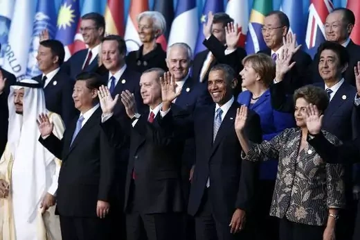 Members of the Group of 20 (G20) wave during the traditional family photo at the G20 leaders summit in the Mediterranean resort city of Antalya, Turkey, November 15, 2015. (Reuters/Aykut Unlupinar)
