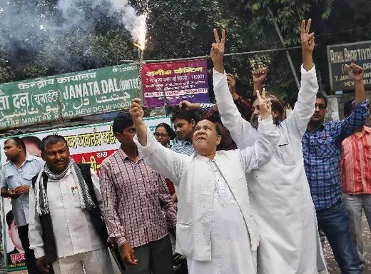 Supporters of Janata Dal (United) celebrate after learning the initial results outside the party office in New Delhi, India, November 8, 2015. Prime Minister Narendra Modi was heading for a heavy defeat on Sunday in a key election in India's third most populous state Bihar, signalling the waning power of a leader who until recently had an unrivalled reputation as a vote winner. Modi's second straight state election setback will galvanise opposition parties, embolden rivals in his own party and diminish his