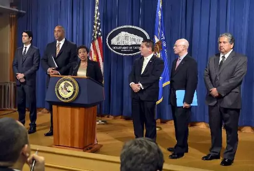 U.S. Attorney General Loretta Lynch (3rd L) makes remarks at a news conference to announce a law enforcement action relating to FIFA, as (L-R) Assistant U. S. Attorney for Eastern District of New York Evan Norris, U.S. Attorney for the Eastern District of New York Robert Capers, FBI Assistant Director New York Field Office Diego Rodriguez, IRS Criminal Investigation Chief Richard Webber and IRS Special Agent in Charge of Los Angeles Field Office Erick Martinez listen, in Washington, December 3, 2015. Offic