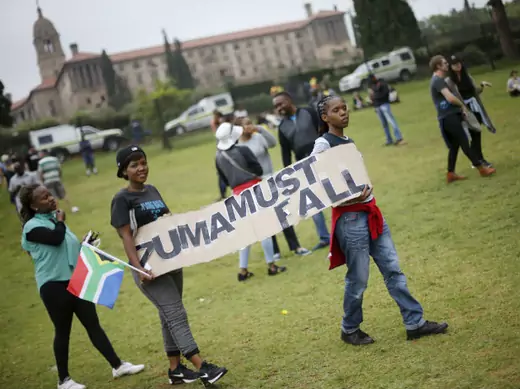 Protesters carry placards as they take part in a "Zuma must fall" demonstration in Pretoria, South Africa, on December 16, 2015.