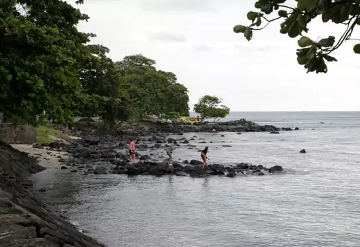 People walk on the rock at the Trou aux Biches beach on the Indian Ocean island Mauritius (Reuters/Jacky Naegelen).
