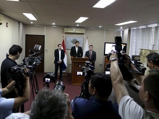 Paraguayan prosecutors Hernan Galeano (C), Federico Espinoza (center, R) and Chief Prosecutor Roberto Zacarias hold a news conference in Asuncion, January 8, 2016. Paraguayan state prosecutors on Thursday raided the headquarters of South American soccer confederation CONMEBOL after a request for cooperation from U.S. justice officials probing corruption inside world soccer, the prosecution office said (Jorge Adorno/Reuters).