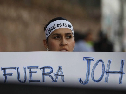 A demonstrator holds a sign that reads "Out JOH", in a reference to Honduras' President Juan Orlando Hernandez, during a march to demand the resignation of Hernandez in Tegucigalpa, August 21, 2015. Thousands of protesters have been continuing demonstrations in Tegucigalpa, calling for the resignation of Hernandez over a $200 million corruption scandal at the Honduran Institute of Social Security (Reuters/Jorge Cabrera).