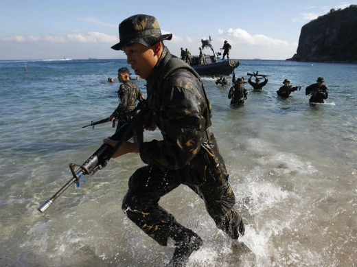 Philippine Military Academy cadets leave their boat and go ashore during a joint field training exercise at a training center south of Manila, the Philippines, on May 29, 2013.