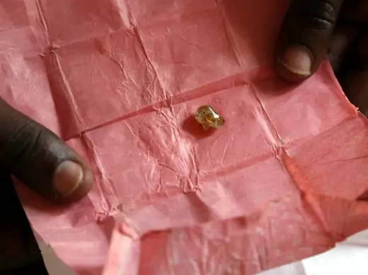 A man displays a rough diamond, from the Boda region, for sale in Bangui May 1, 2014. Despite a 2013 ban on diamond exports by The Kimberley Process, a global watchdog set up to stop the trade in "blood diamonds", rough diamonds are still commonly offered for sale in Central African Republic (Reuters/Emmanuel Braun).